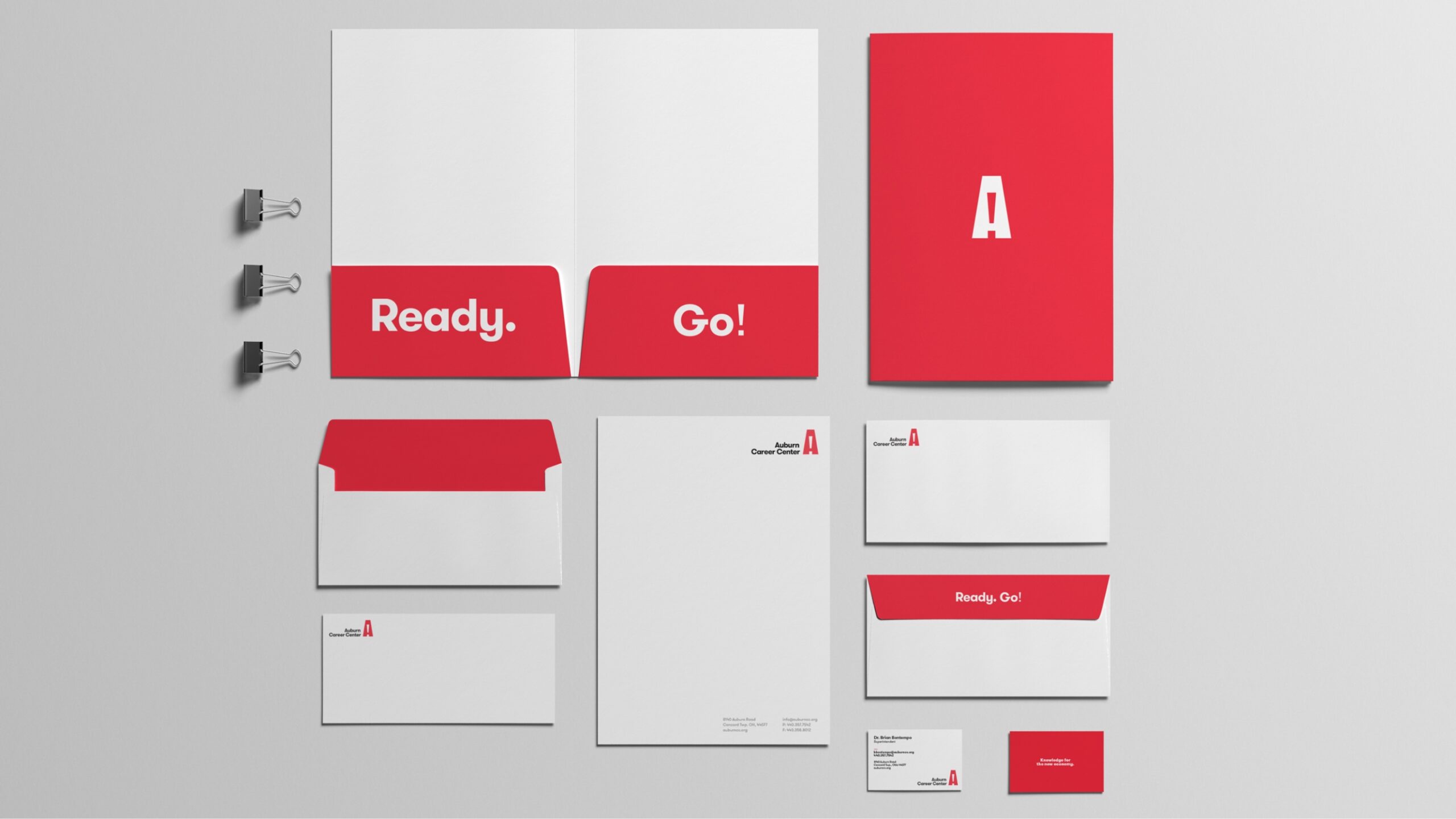 various auburn collateral pieces like folders and letterhead with logo and branding