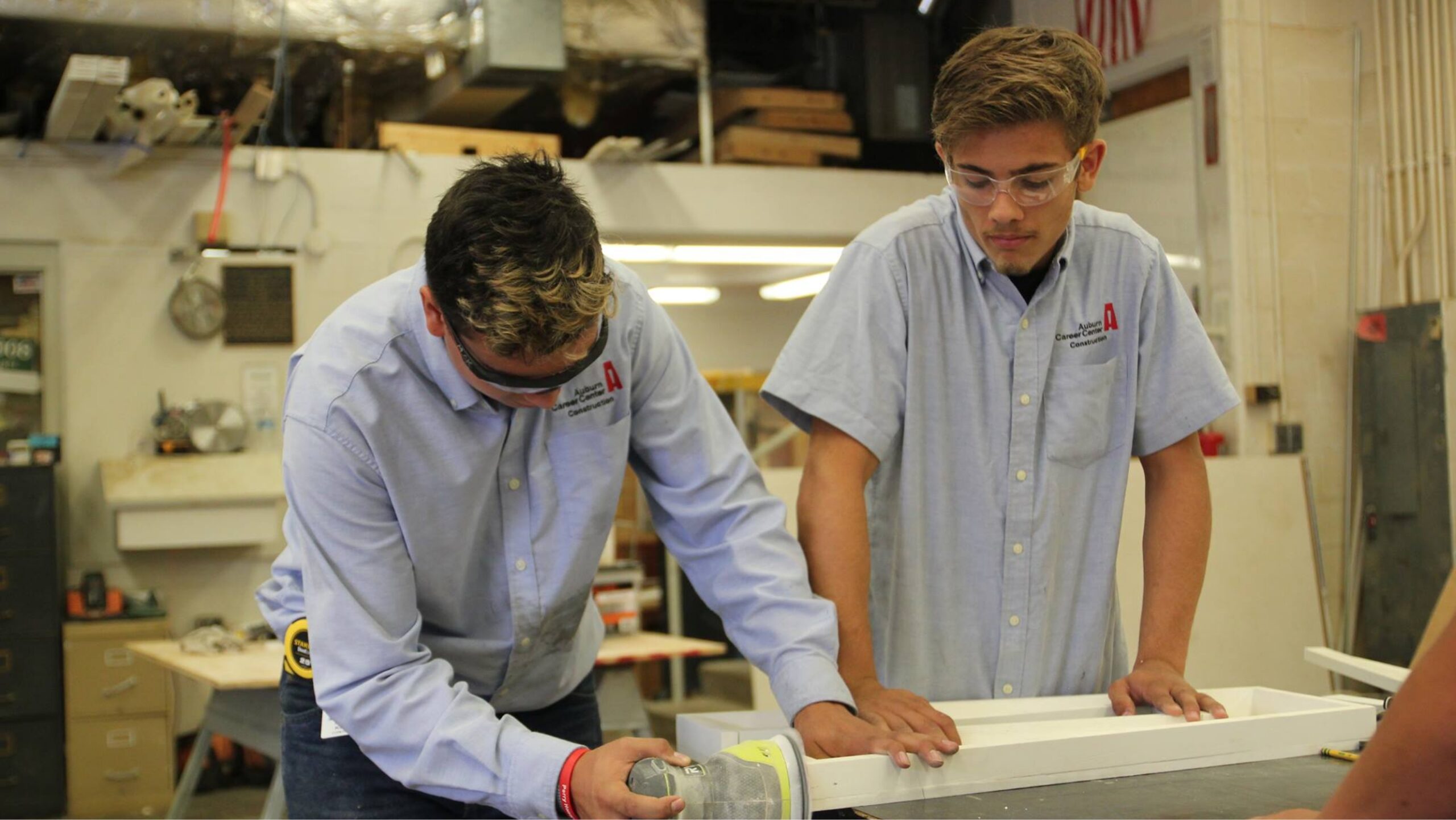 two students working on a machine