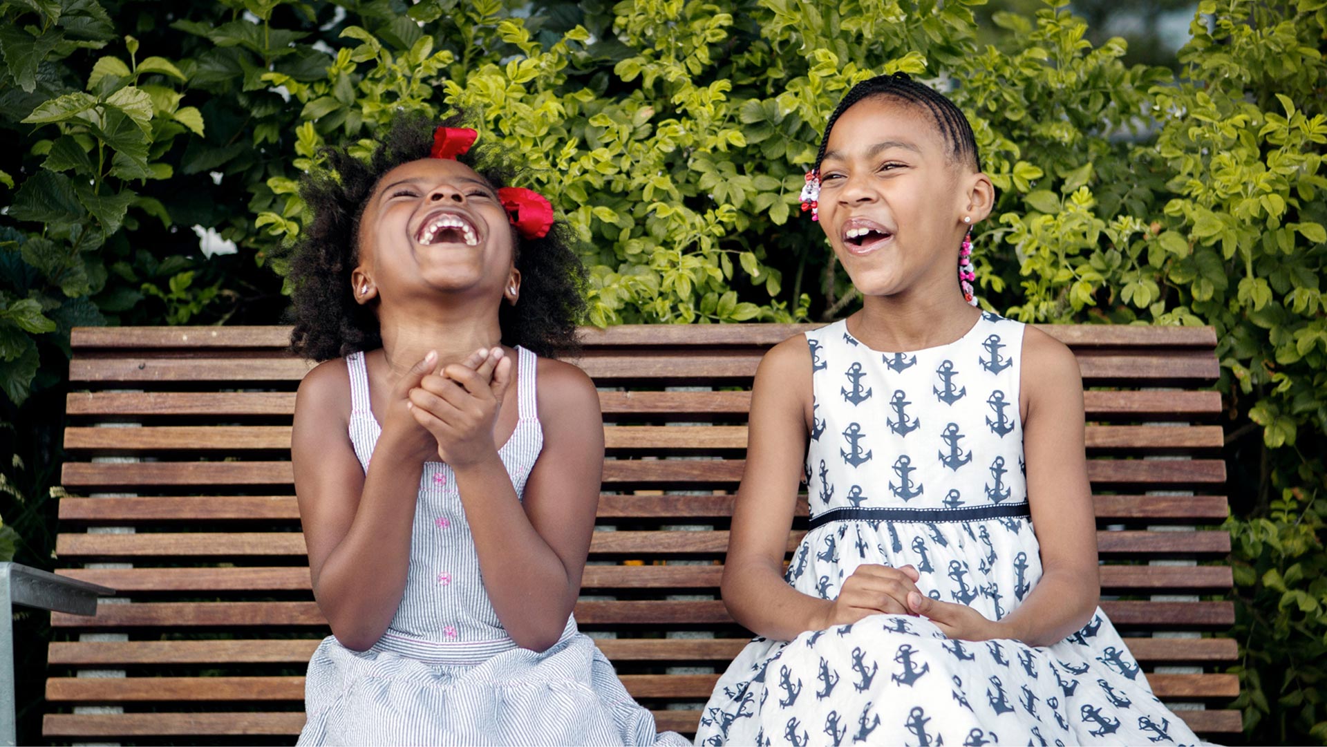 young girls sitting on bench