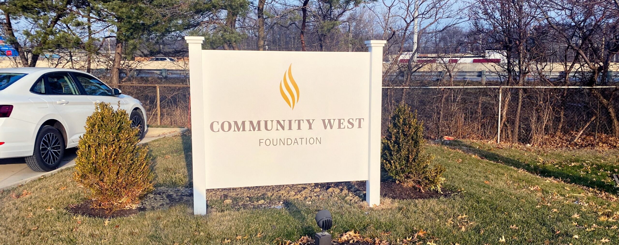 large sign outside of business with community west logo