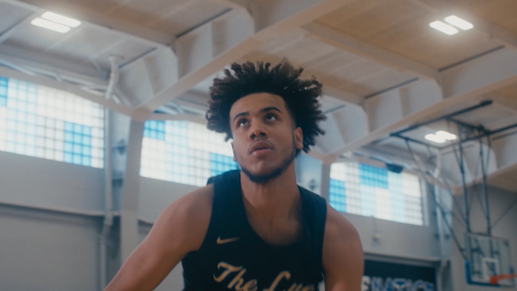 male student playing basketball