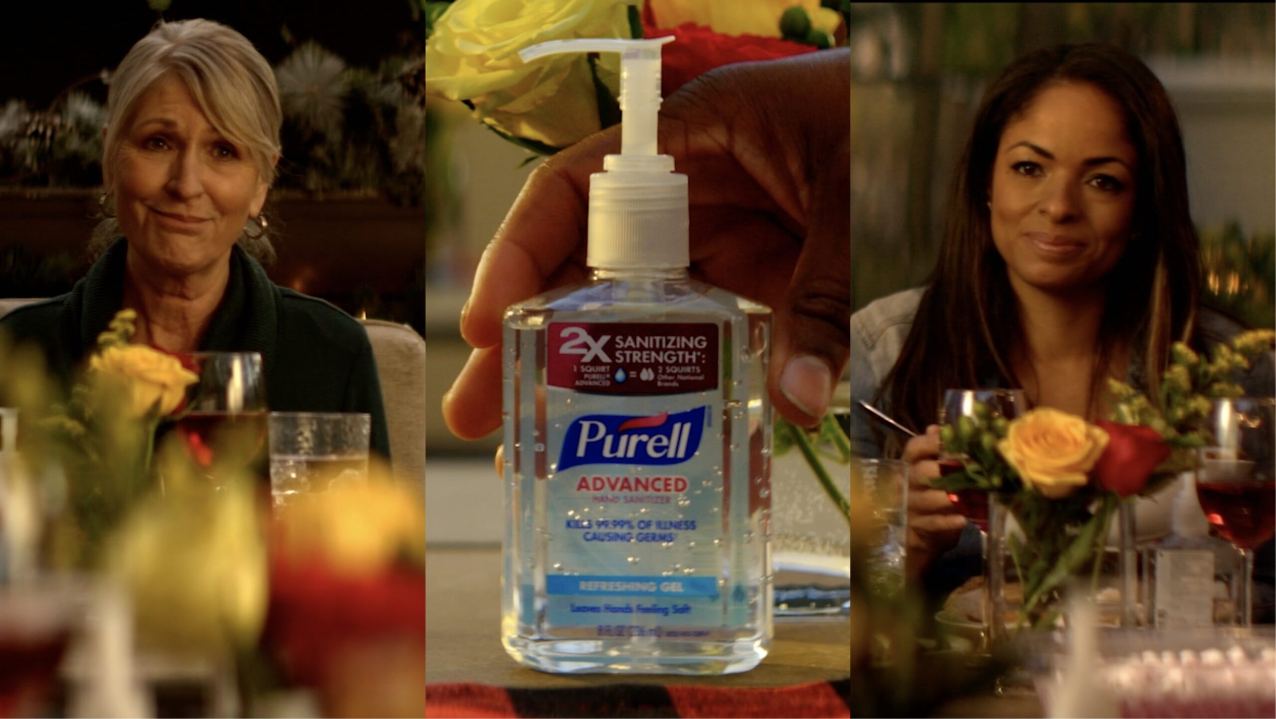 Two women sitting at table with PURELL bottle